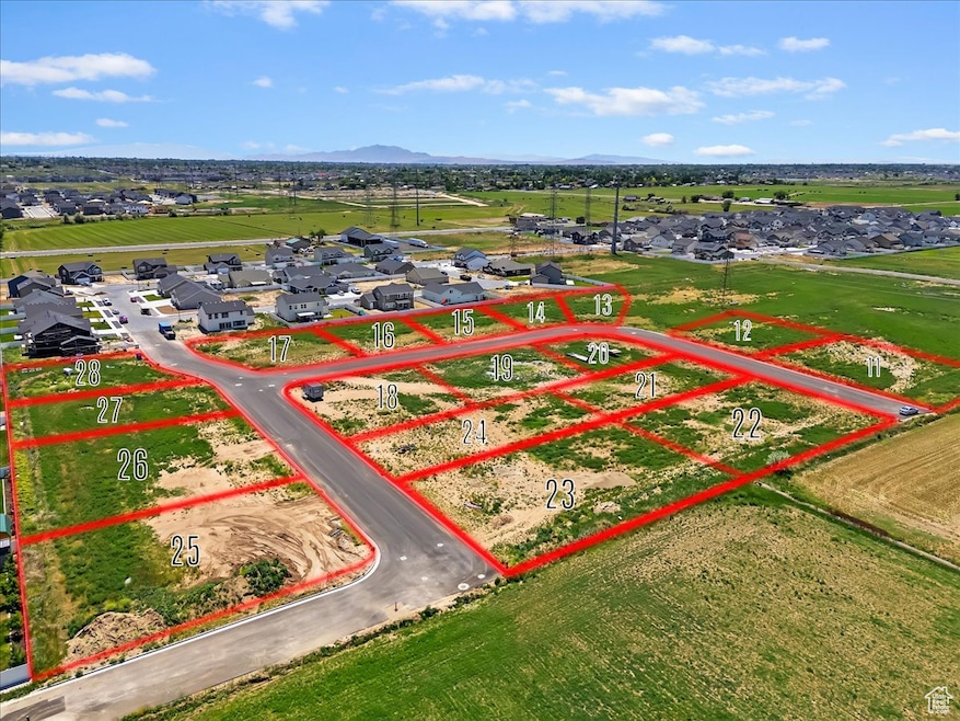 Aerial perspective of suburban area featuring property parcel outlined and a mountainous background