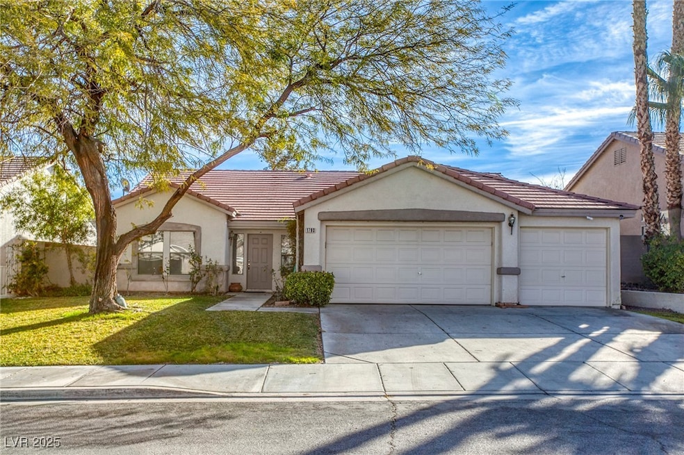 Single story home featuring a garage, stucco sidin