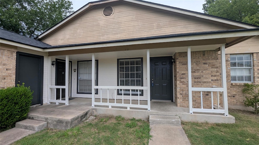 Doorway to property featuring brick siding and a 