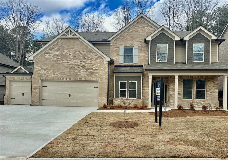 Craftsman-style house with a garage and covered po
