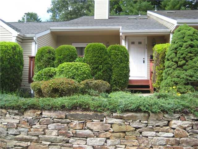 Exterior Front. Gorgeous stone wall with shrubs fo