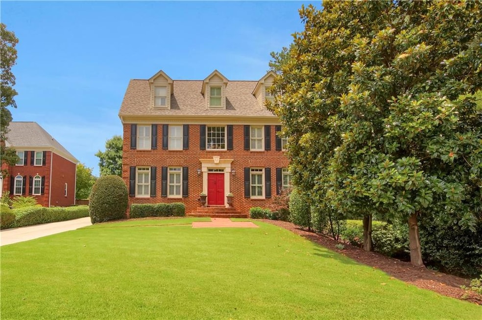 View of front facade with a front lawn and brick siding