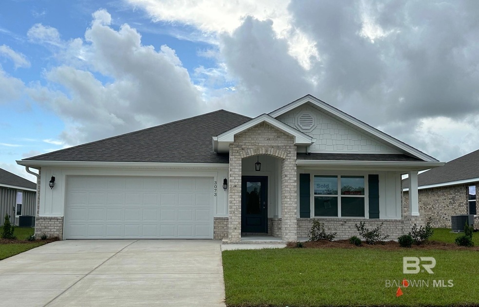 View of front of property with a garage, a front yard, and central AC
