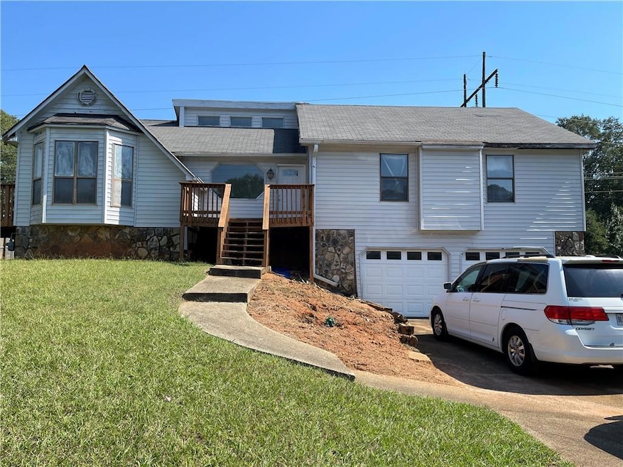 View of front of house with a wooden deck, a front