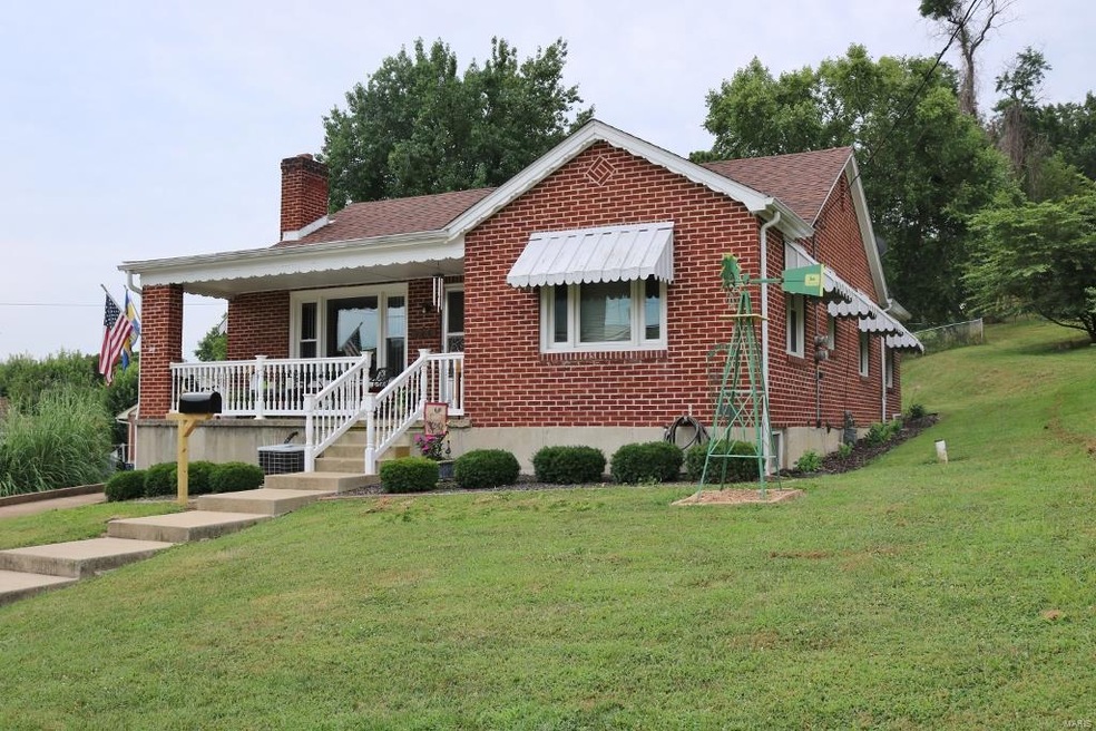 Front View of adorable brick cottage-style home.
