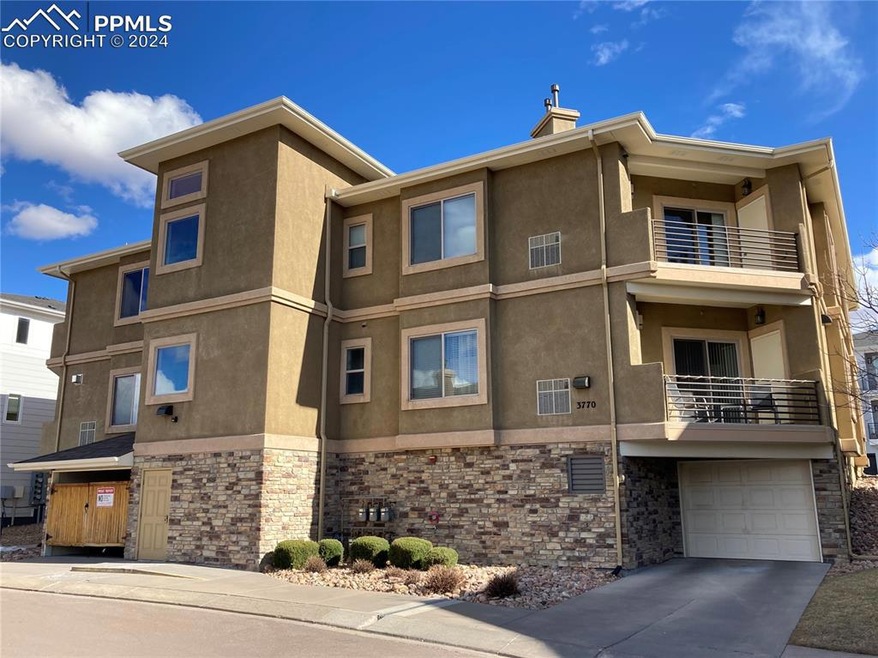 View of condo featuring beautiful stucco & stone e