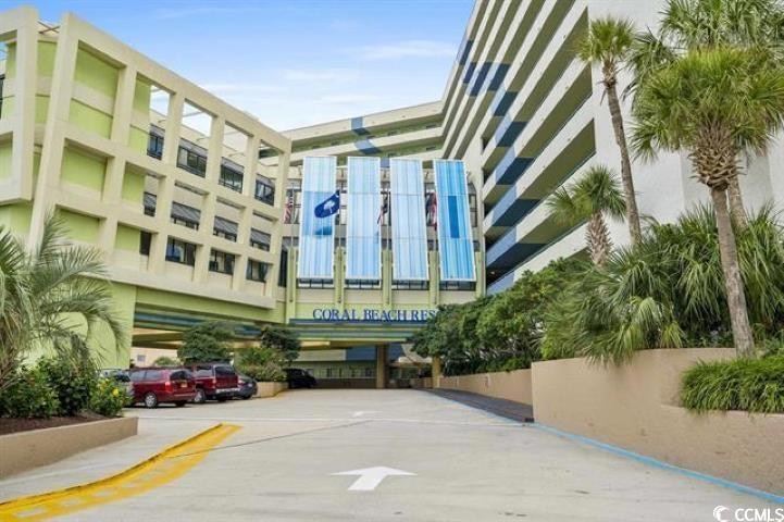 View of property featuring uncovered parking