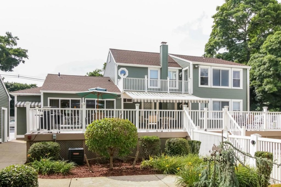 Back of home shows deck and entrance to in-ground,