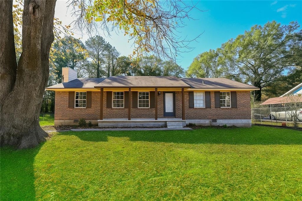 View of front of property featuring crawl space, brick siding, a porch, and a chimney