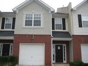 Townhome / multi-family property featuring a garag