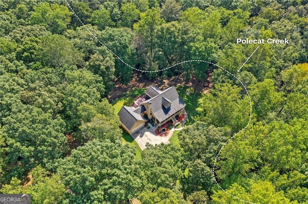 Aerial view of the home. Look at that privacy and how much creek frontage there is!
