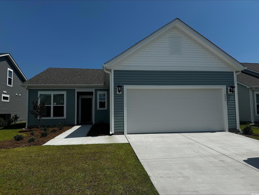 View of front of property with a garage and a front lawn