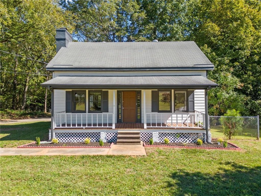 View of front of home with covered porch and a fro