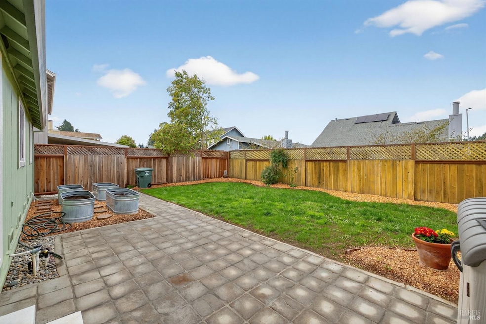 Roomy backyard with patio pavers, privacy wood fencing and garden troughs ready to plant!