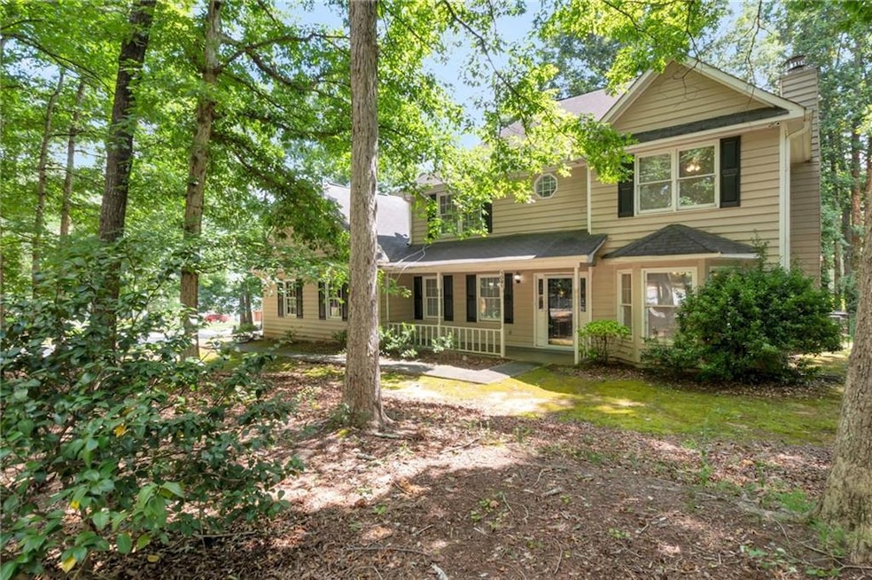 View of front of property with a porch and a chimney
