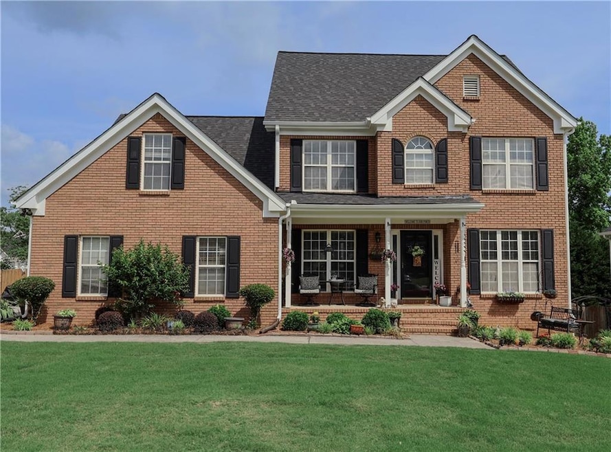 Traditional-style house featuring a porch, brick s