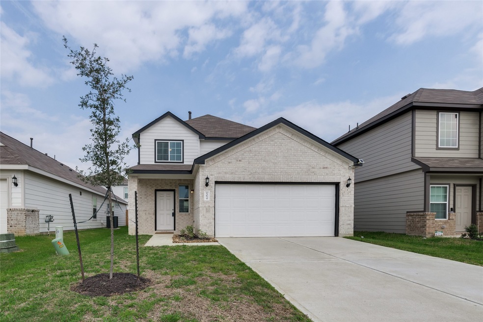 Great front brick elevation with large doublewide drive and two car garage