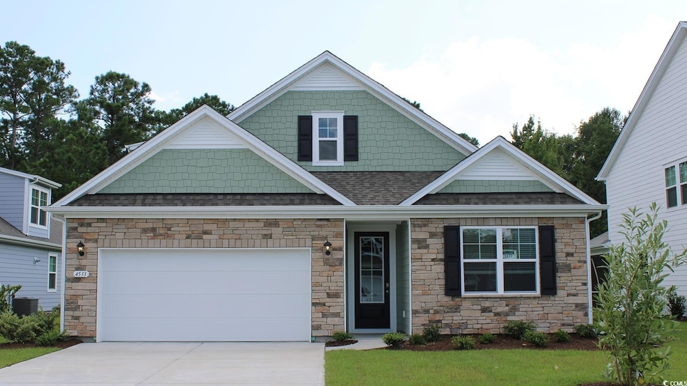 View of front of home with driveway, stone siding,