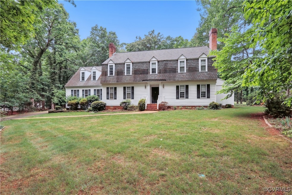 Colonial inspired home featuring a chimney, a fron