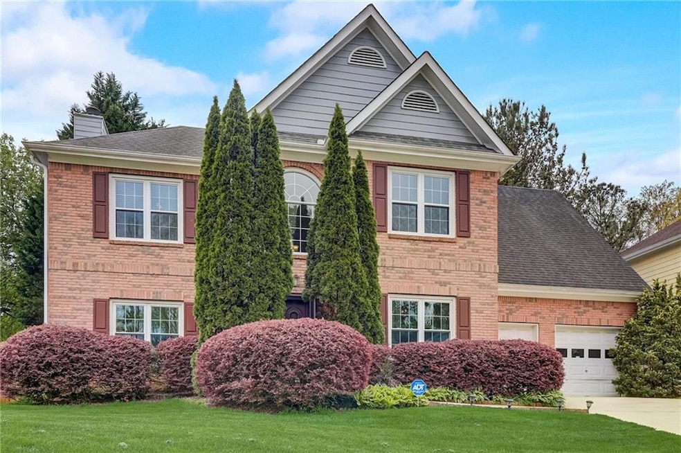 Front of property with a front yard and a garage