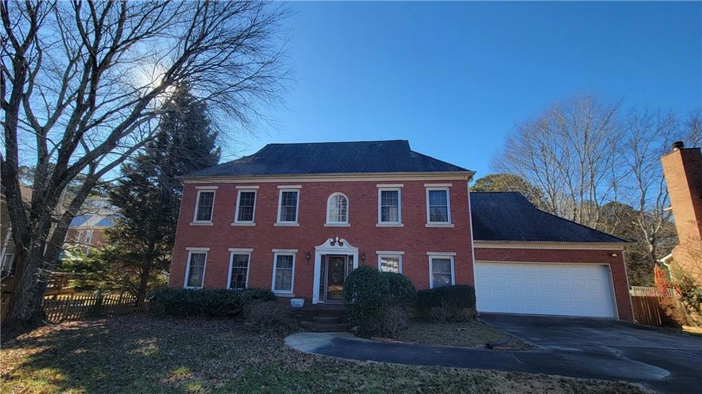 Colonial house featuring a garage