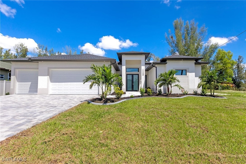 View of front of house with stucco siding, an atta