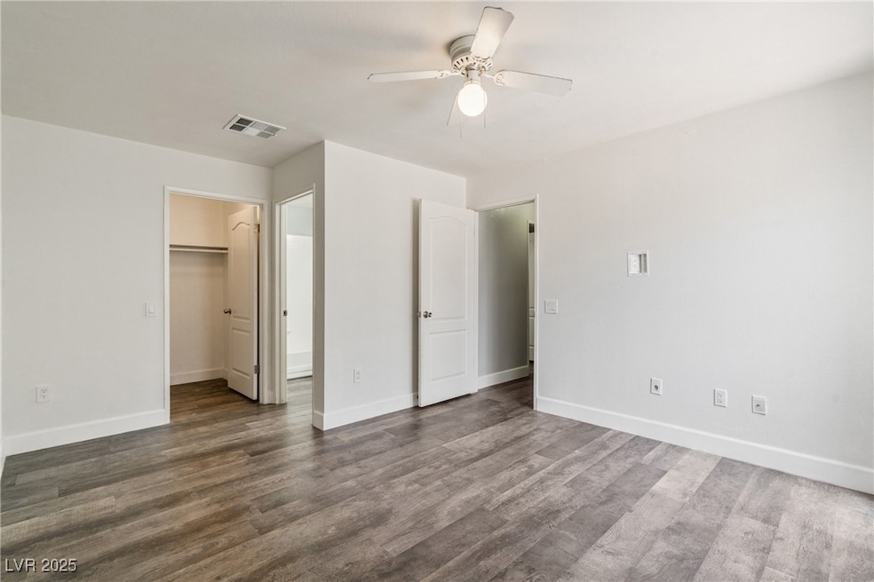 Unfurnished bedroom with dark wood-style flooring,