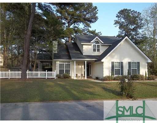 Exterior Front. Corner lot, side-enrty garage, and