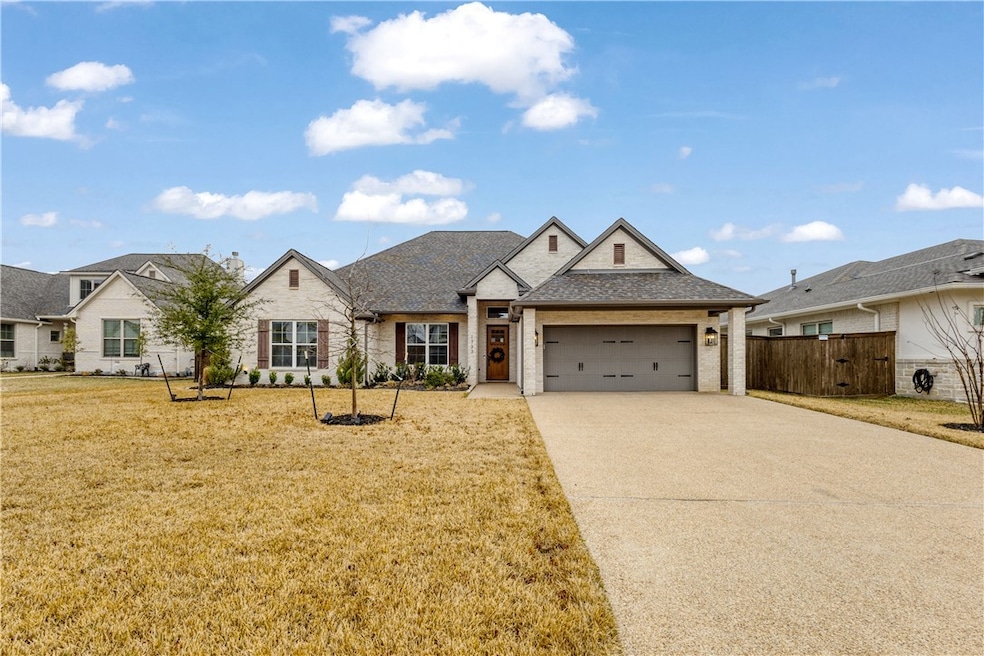View of front of house with a garage, concrete dri