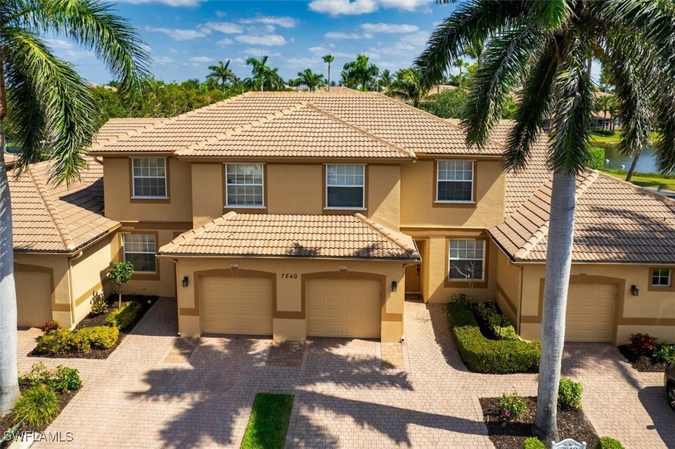 View of property featuring a tile roof, stucco sid