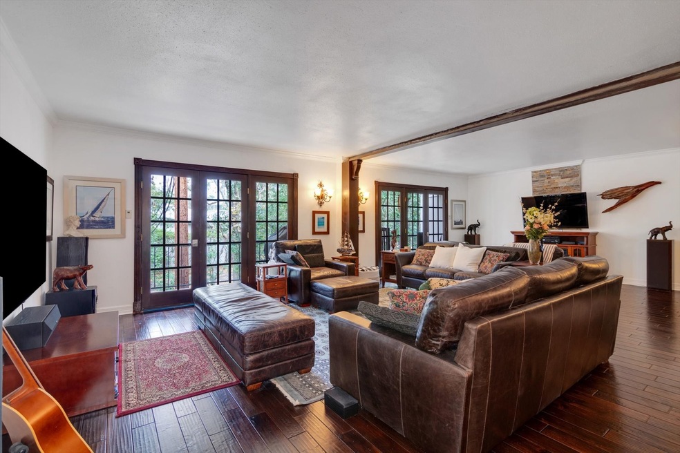 Open living room concept featuring beautiful french doors to the balcony.