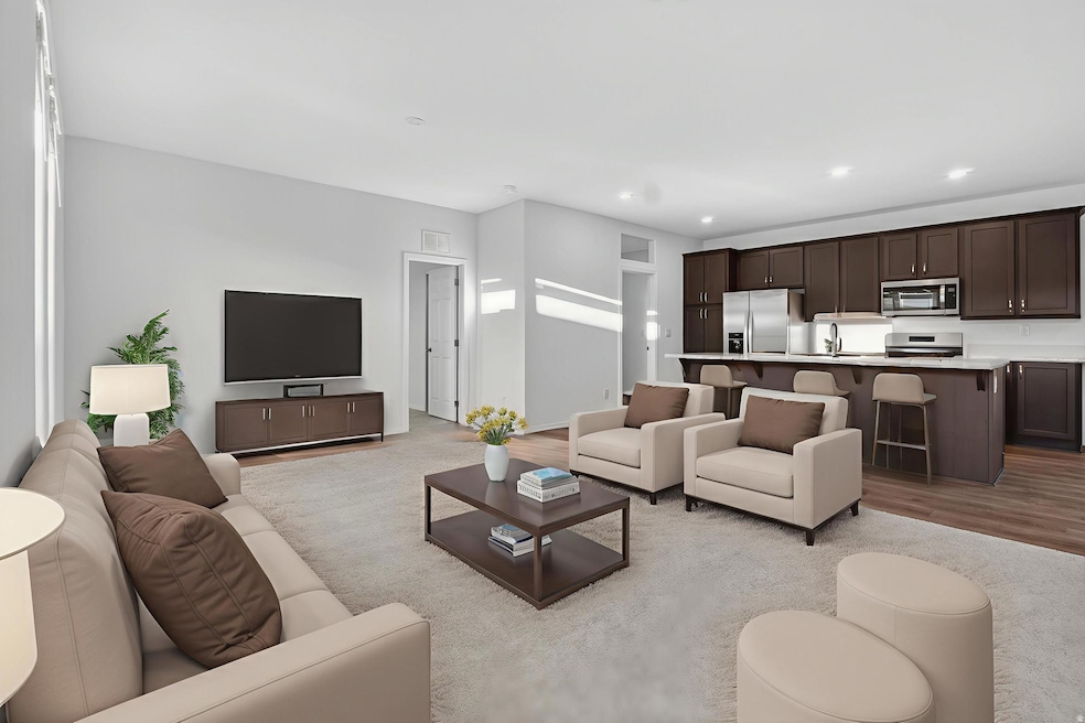 Living room with wood finished floors and recessed lighting