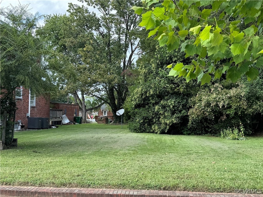 View of yard with cooling unit and a deck