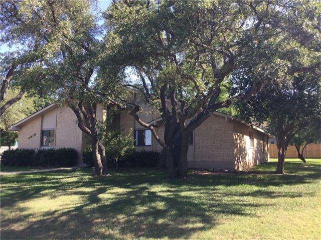 Front view of house. Oak trees in front.  Peach tr