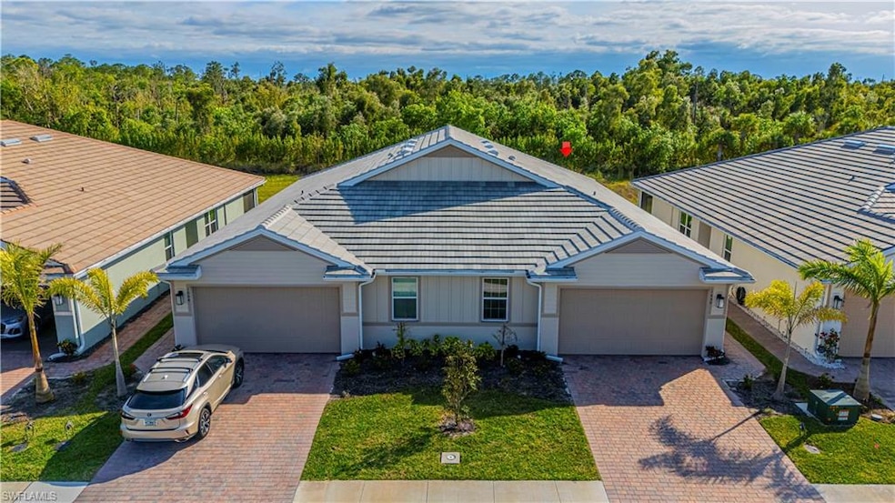 View of front of property with a garage, a tiled r