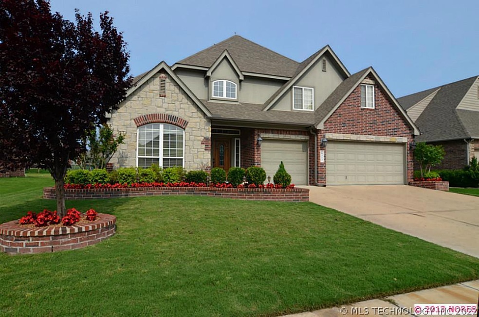 Brick and stone exterior with 3-car garage and bri