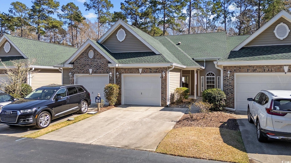Multi unit property featuring concrete driveway, a