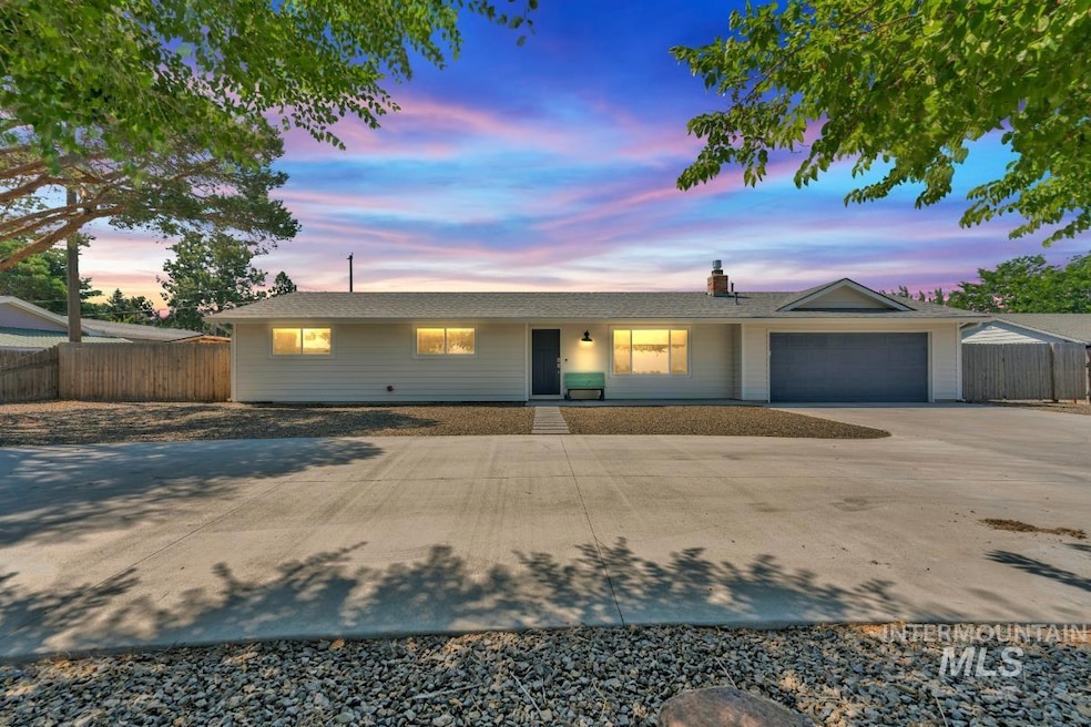 Single story home with a garage, concrete driveway, and a chimney