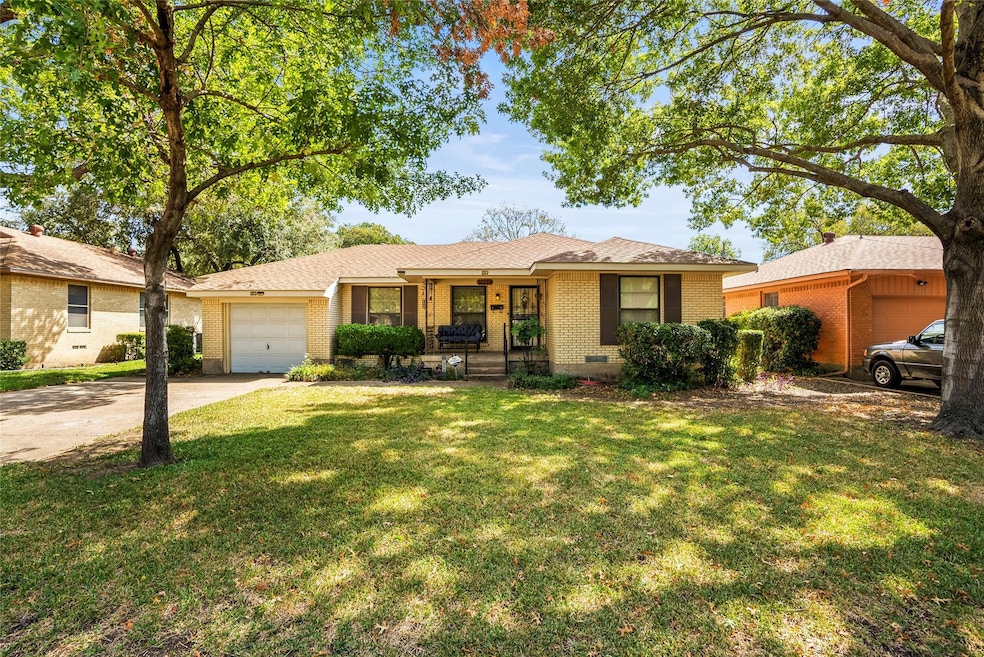 Single story home with a garage, a front lawn, and