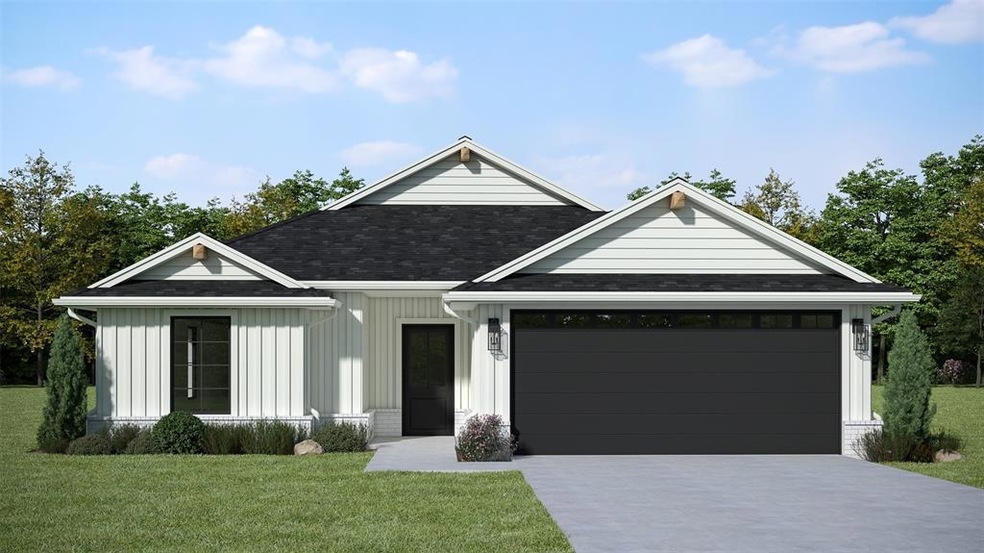 View of front of home with a garage and a front ya