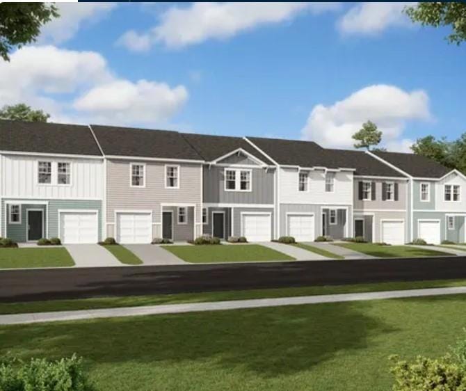 View of property featuring a garage and a front ya