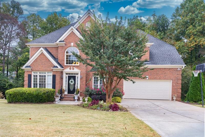 Brick home with level driveway, NEWER ROOF, lush l