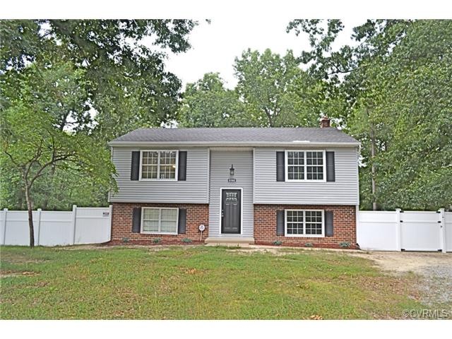 Front view of home flanked by privacy fencing with