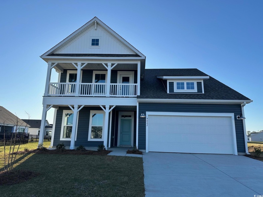 View of front of house with concrete driveway, roo