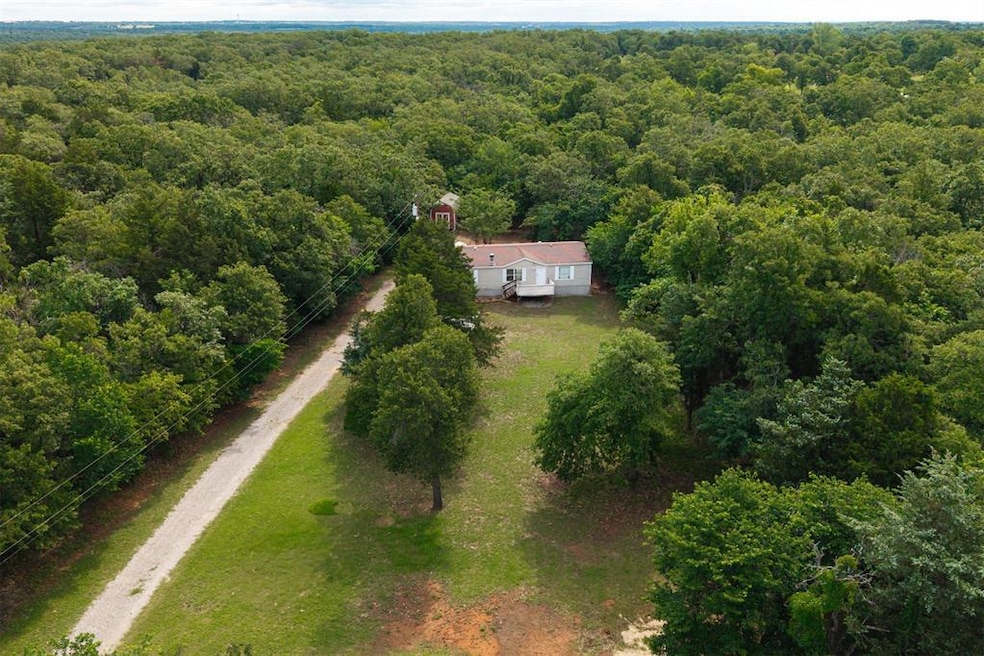 View of subject property featuring a forest