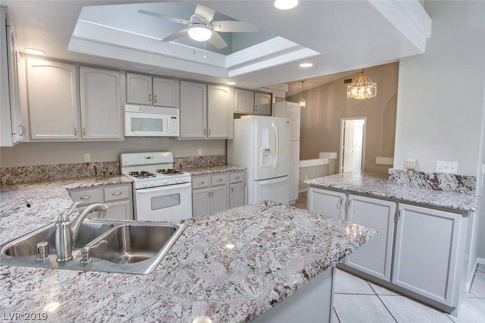 Kitchen features granite counters, breakfast bar,