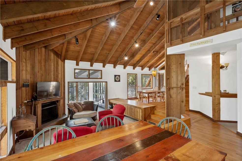 Dining space with high vaulted ceiling, beam ceili