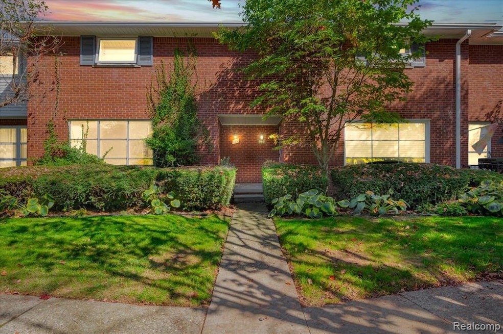 Traditional-style home featuring brick siding and a front yard