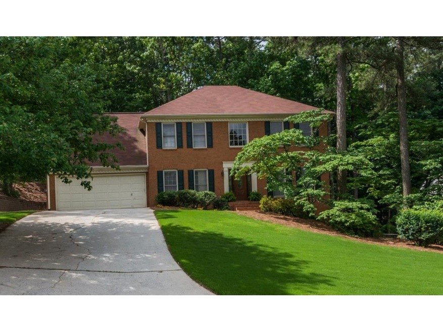 The beautiful brick home is nestled on almost half