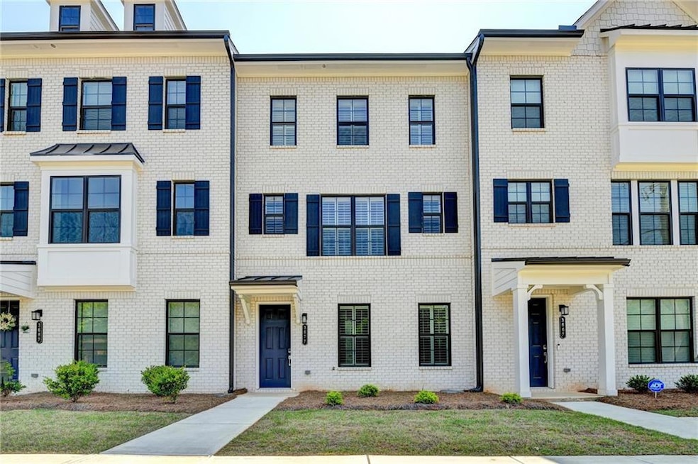Townhome / multi-family property featuring brick s